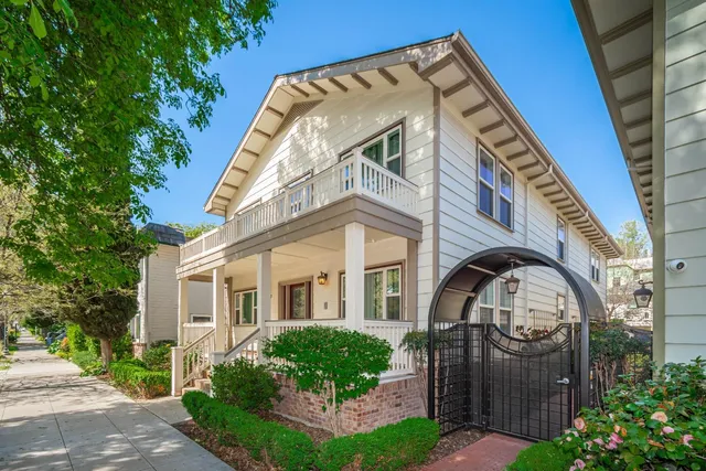 a front view of a house with a garden
