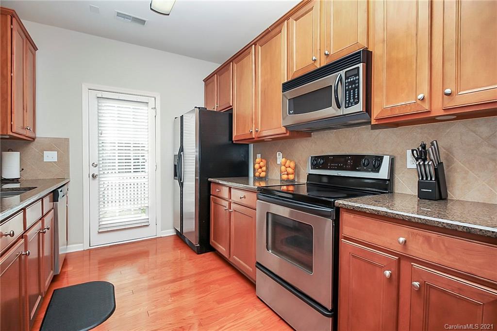 2139 Midnight Blue Lane Fort Mill, SC 29708 - Photo 2 of 23 a kitchen with stainless steel appliances granite countertop a stove microwave refrigerator and sink