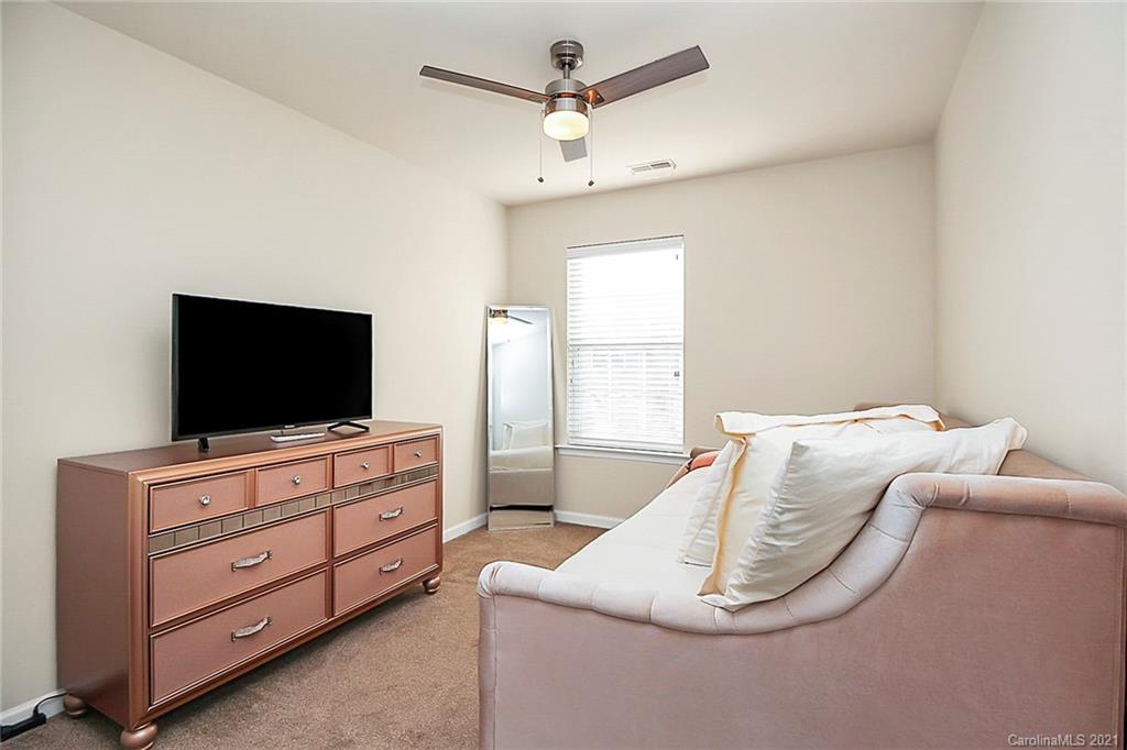 2139 Midnight Blue Lane Fort Mill, SC 29708 - Photo 11 of 23 a bedroom with a bed and a flat screen tv