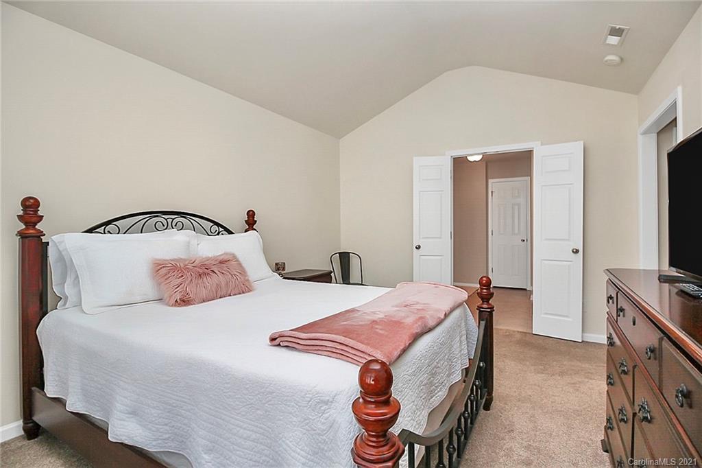 2139 Midnight Blue Lane Fort Mill, SC 29708 - Photo 14 of 23 a bedroom with a bed and a flat tv screen on wall
