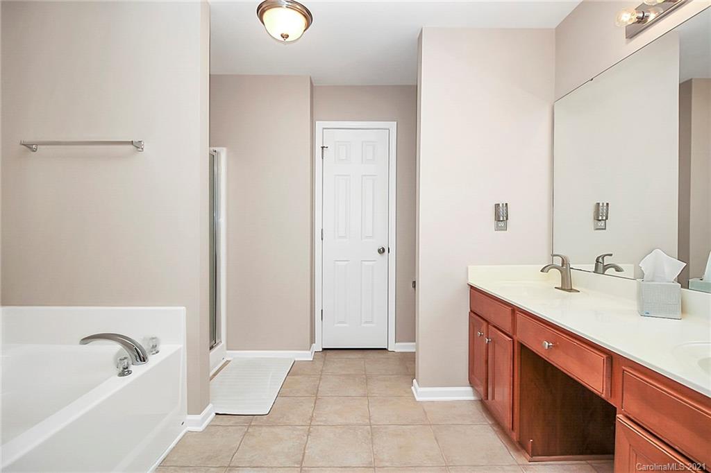 2139 Midnight Blue Lane Fort Mill, SC 29708 - Photo 16 of 23 a spacious bathroom with a tub sink and mirror