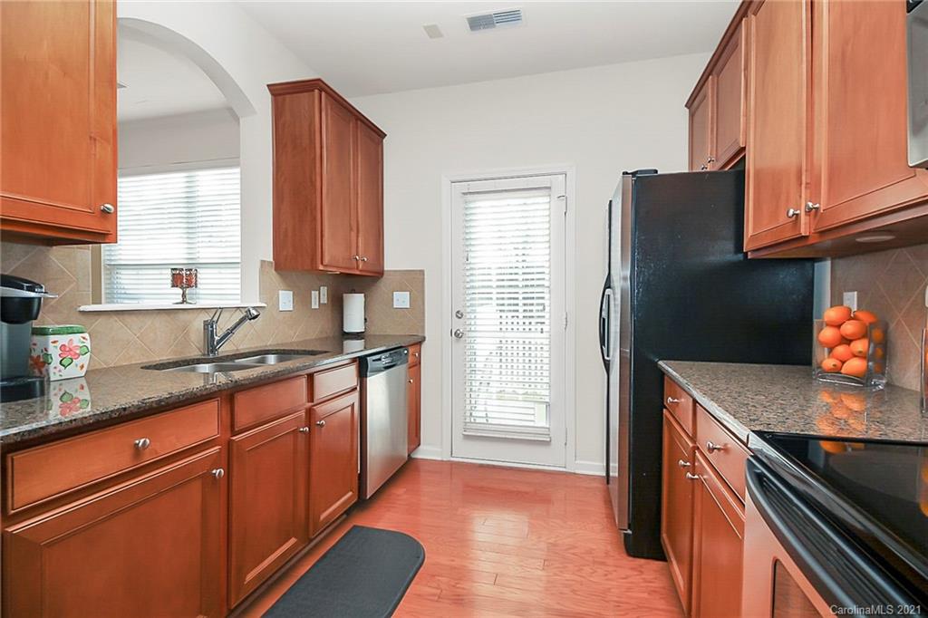 2139 Midnight Blue Lane Fort Mill, SC 29708 - Photo 3 of 23 a kitchen with granite countertop cabinets stainless steel appliances a sink and a window
