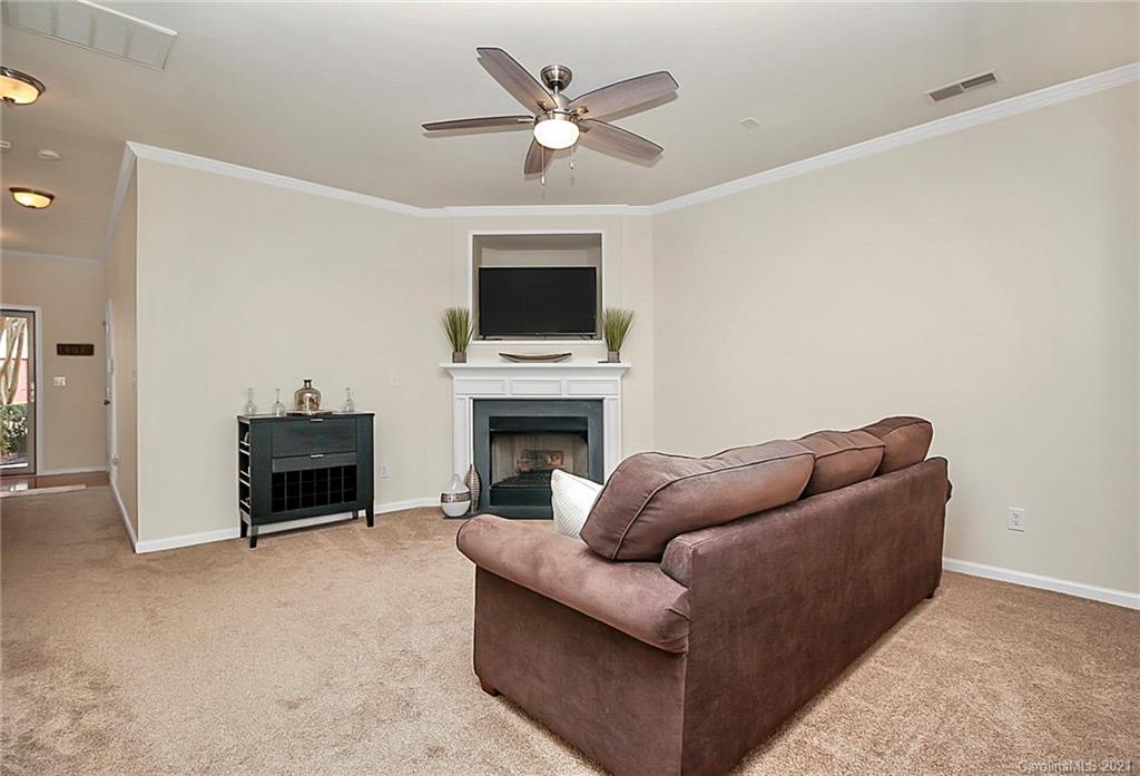 2139 Midnight Blue Lane Fort Mill, SC 29708 - Photo 5 of 23 a living room with furniture a fireplace and a flat screen tv