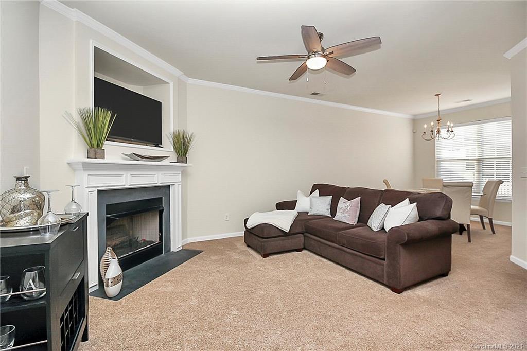 2139 Midnight Blue Lane Fort Mill, SC 29708 - Photo 6 of 23 a living room with furniture a fireplace and a flat screen tv