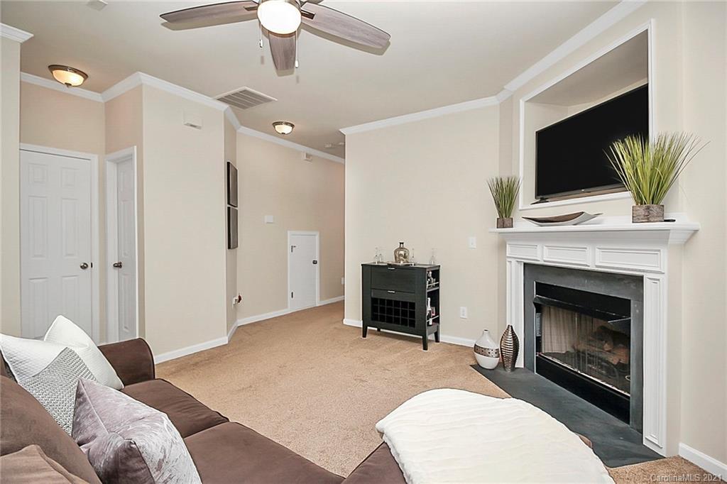 2139 Midnight Blue Lane Fort Mill, SC 29708 - Photo 7 of 23 a living room with furniture a flat screen tv and a fireplace