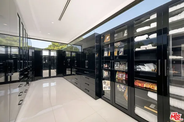 a view of a patio with table and chairs and potted plants with wooden floor