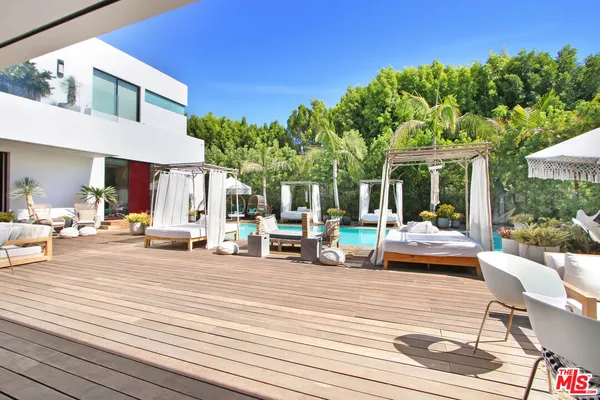 a view of a house with swimming pool and sitting area