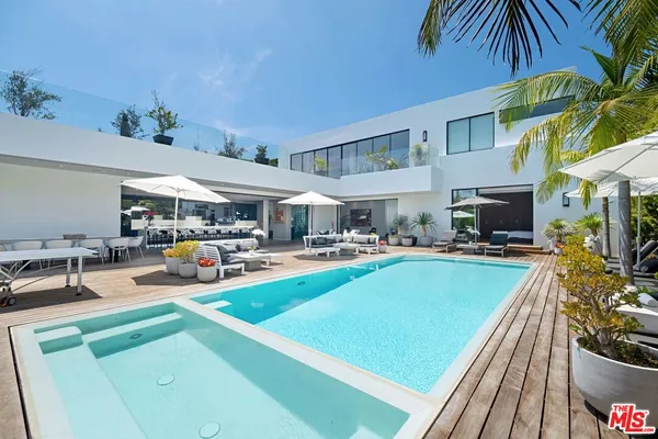 a view of a patio with swimming pool table and chairs