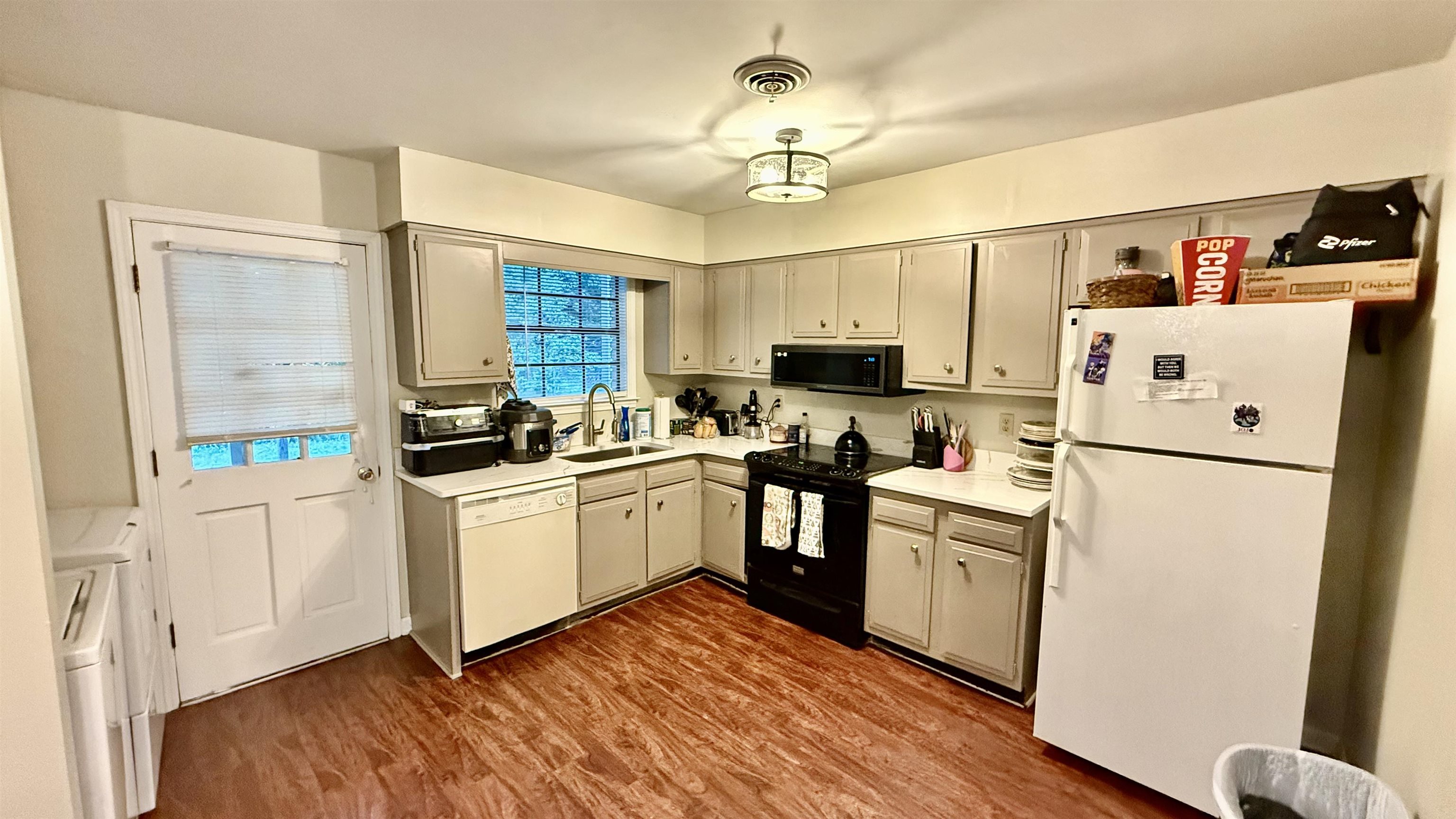 379 Dove Valley Road Collierville, TN 38017 - Photo 3 of 12 Kitchen with white appliances, a sink, light countertops, and dark wood-style floors