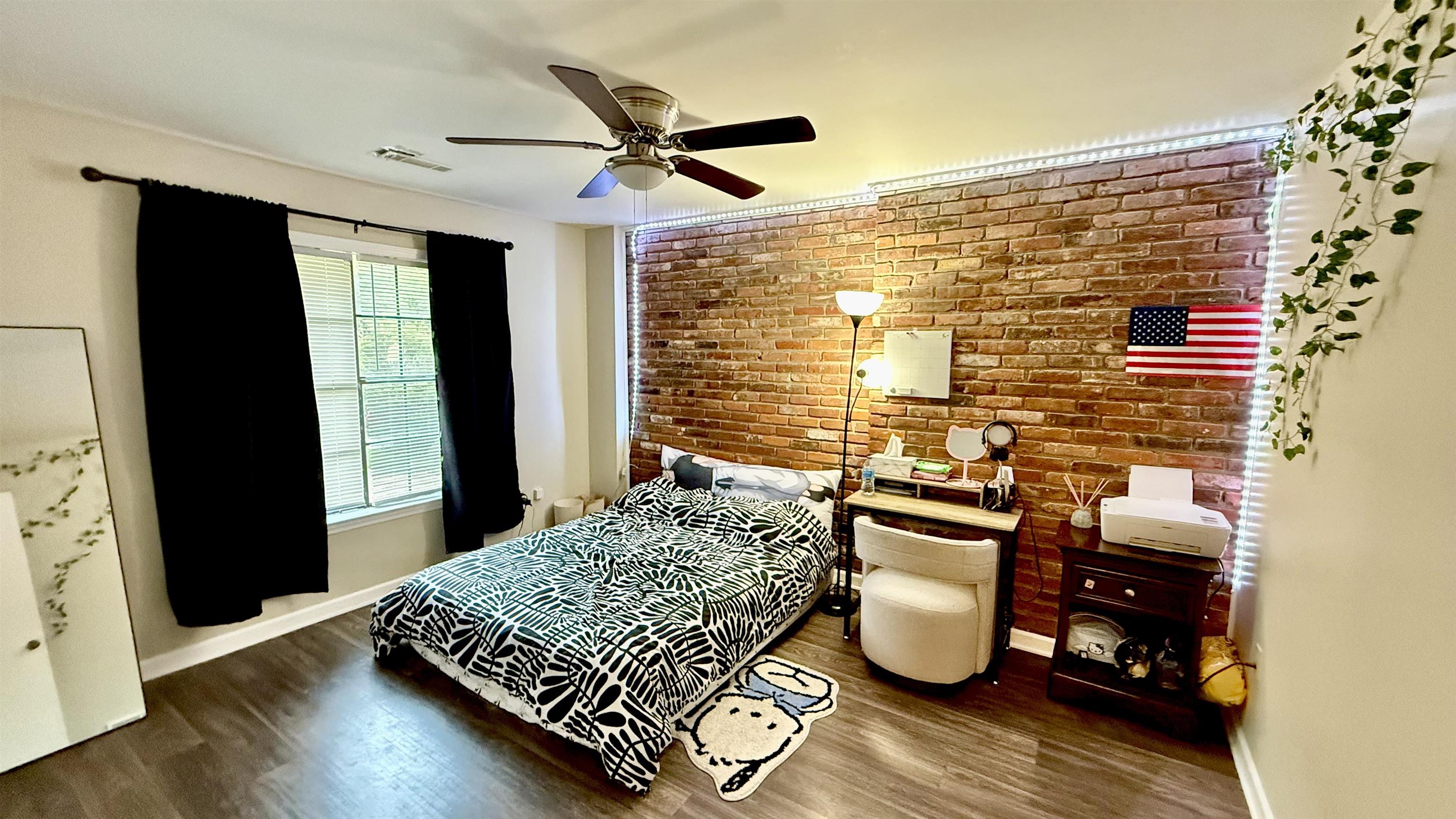 379 Dove Valley Road Collierville, TN 38017 - Photo 5 of 12 Bedroom featuring brick wall, baseboards, and wood finished floors