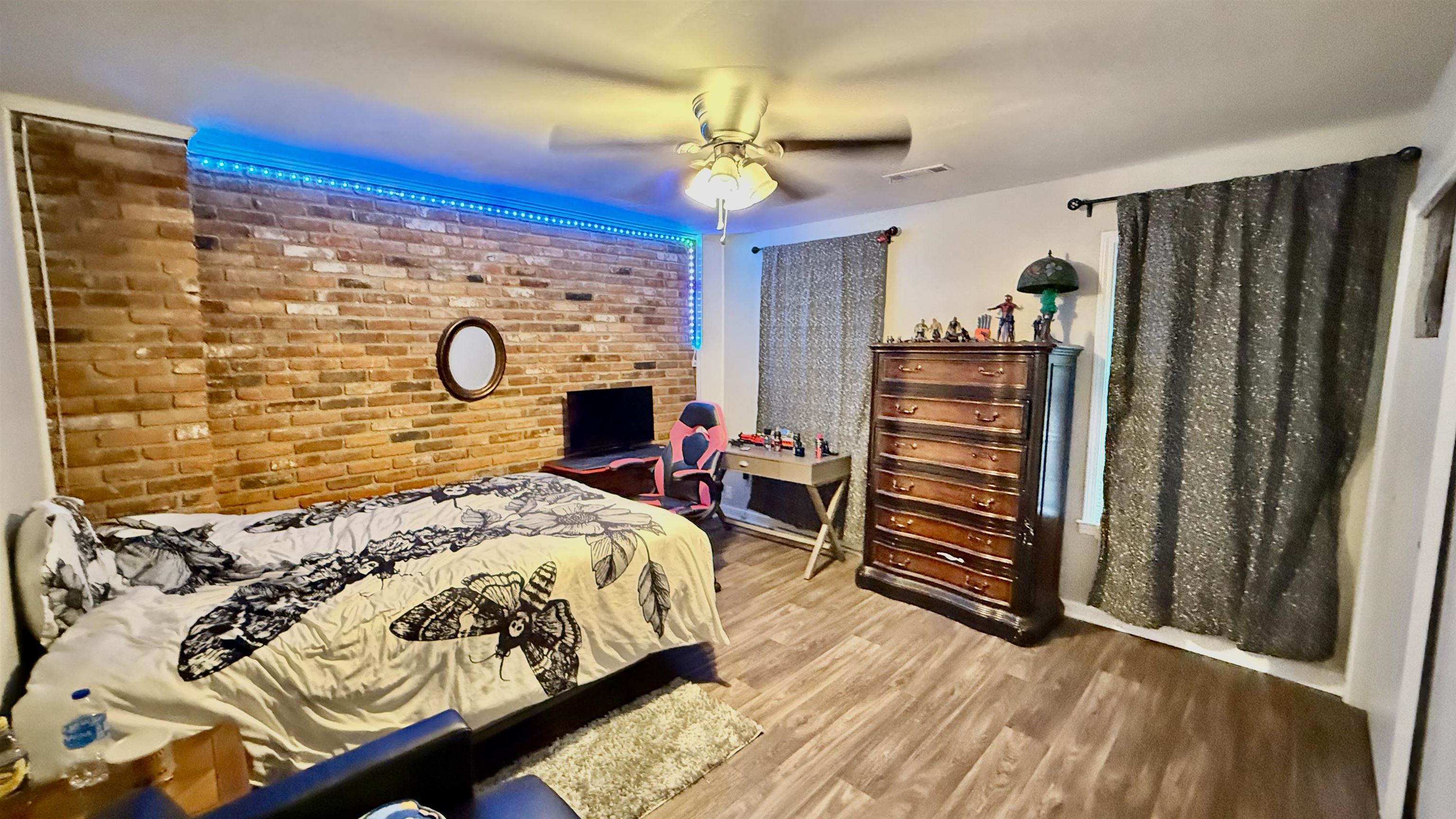 379 Dove Valley Road Collierville, TN 38017 - Photo 6 of 12 Bedroom featuring brick wall, wood finished floors, and a ceiling fan