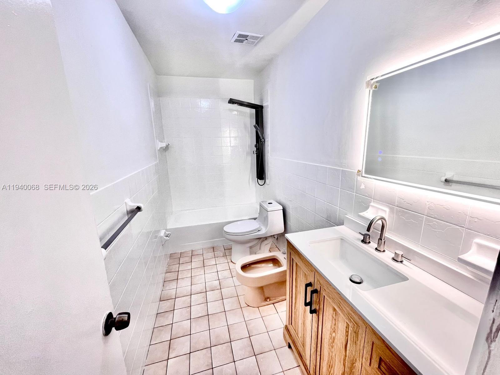 1348 Southwest 2nd Street, Unit 8 Miami, FL 33135 - Photo 11 of 37 a bathroom with a sink a toilet and shower