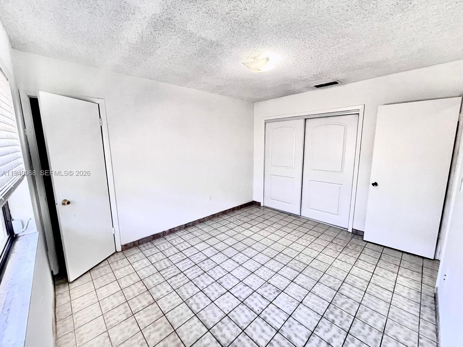 1348 Southwest 2nd Street, Unit 8 Miami, FL 33135 - Photo 19 of 37 an empty room with windows