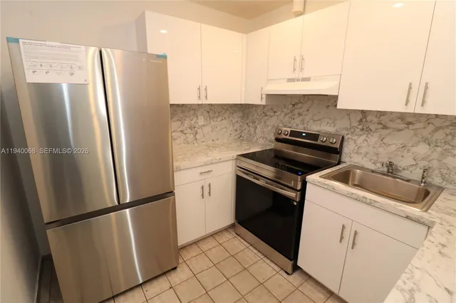 a kitchen with a refrigerator stove and sink