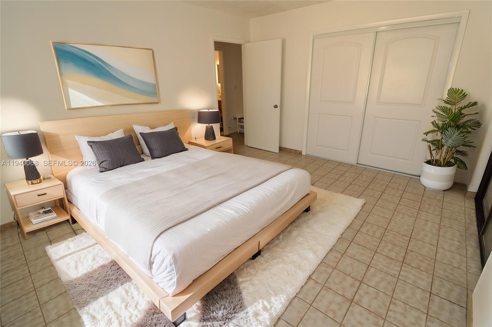 1348 Southwest 2nd Street, Unit 8 Miami, FL 33135 - Photo 4 of 37 a bedroom with a bed and a potted plant