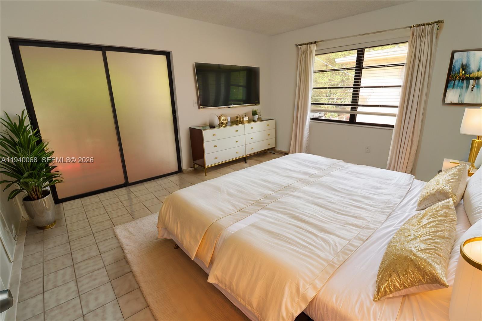 1348 Southwest 2nd Street, Unit 8 Miami, FL 33135 - Photo 6 of 37 a bedroom with a bed and a television