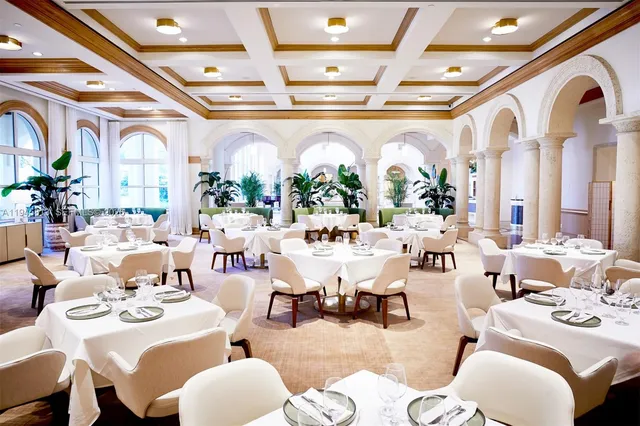 a very nice looking room with lots of white furniture