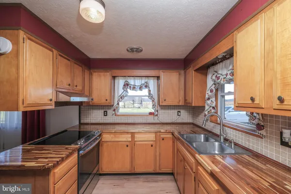 a kitchen with sink and cabinets