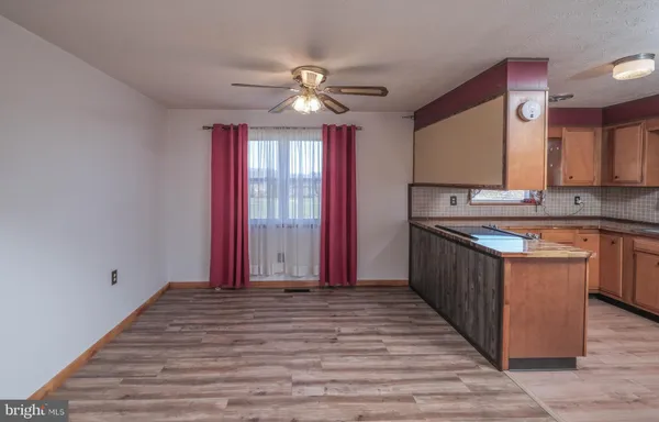 a kitchen with a refrigerator and a stove top oven