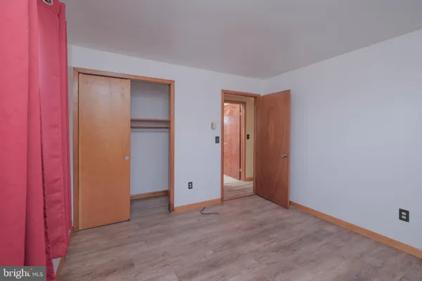 a view of a room with wooden floor and windows