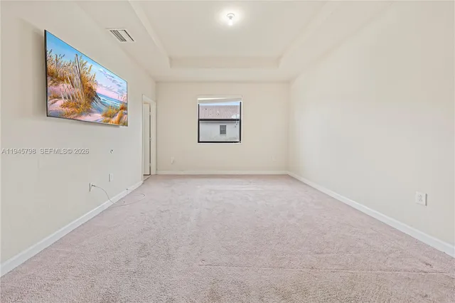 a view of an empty room with painting on the wall