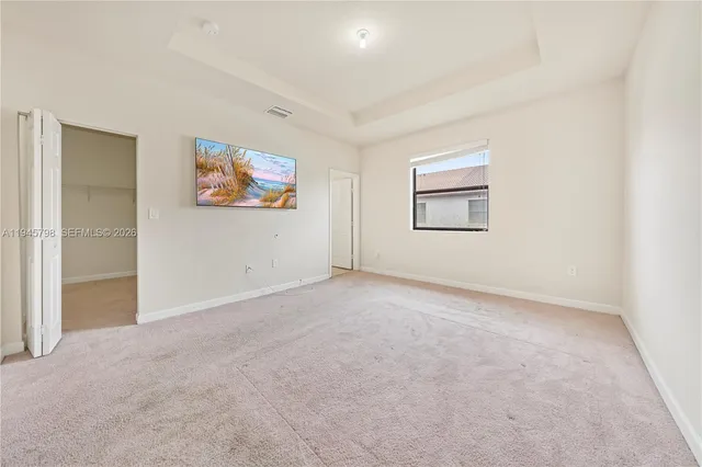 an empty room with windows and painted walls