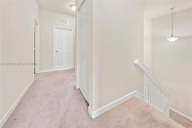 a view of a hallway with white walls