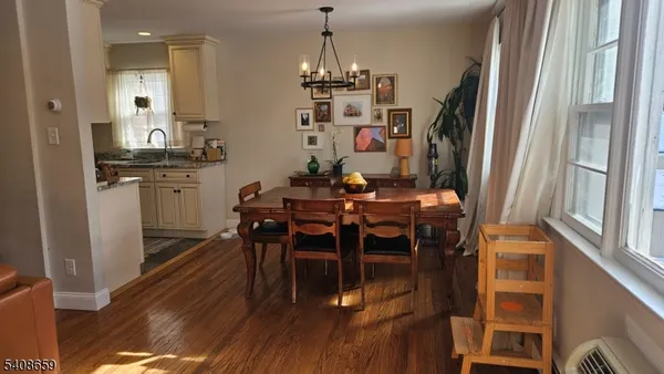 a dining room with furniture window and wooden floor