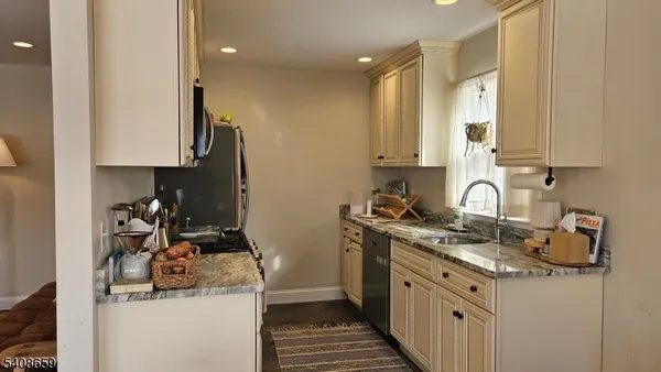 a kitchen with a sink stove and cabinets