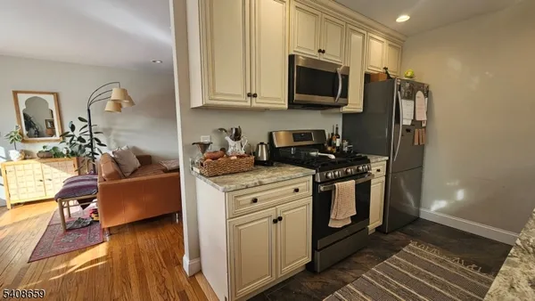 a kitchen with stainless steel appliances granite countertop a stove a sink dishwasher a microwave oven with granite countertops and cabinets