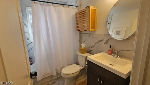 a bathroom with a sink toilet and a mirror