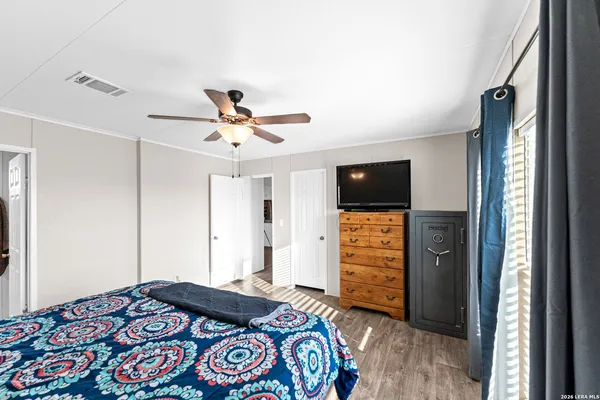 a bedroom with a bed and a television