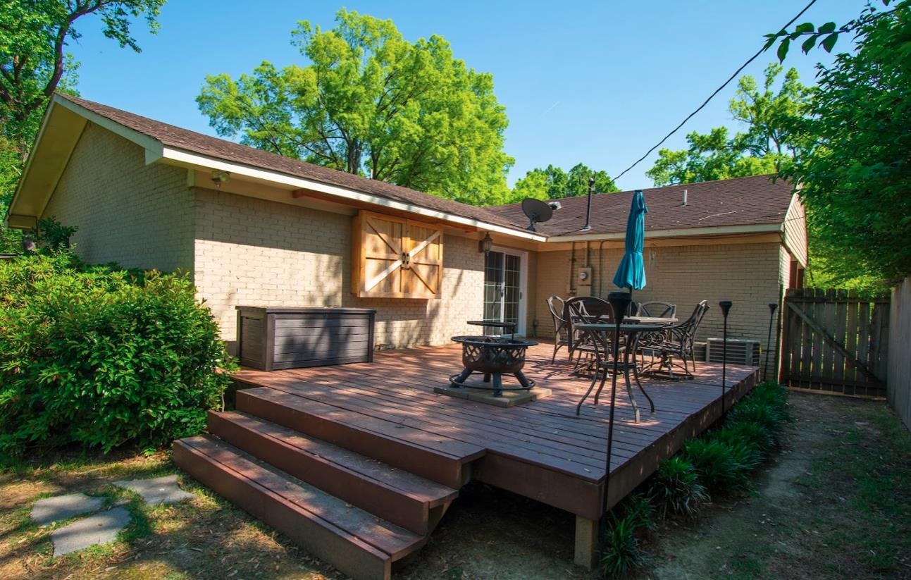 4964 Flamingo Road Memphis, TN 38117 - Photo 18 of 18 a view of a patio with table and chairs potted plants and a large tree