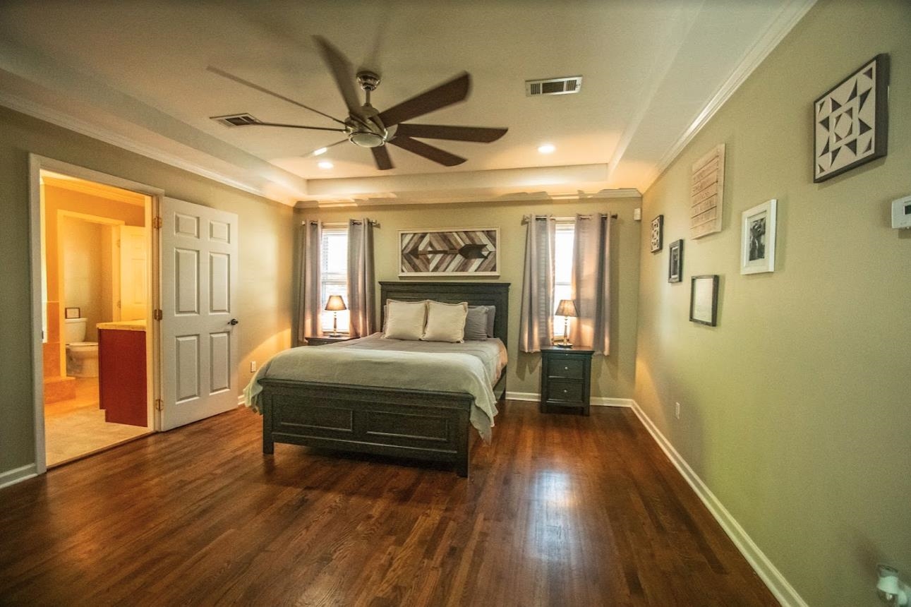 4964 Flamingo Road Memphis, TN 38117 - Photo 8 of 18 a bedroom with a bed and wooden floor