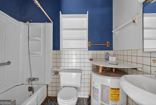 a bathroom with a sink a toilet and bathtub
