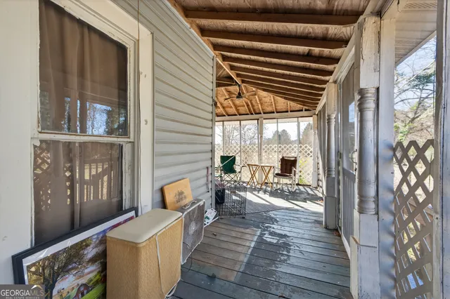 a balcony with wooden floor and furniture