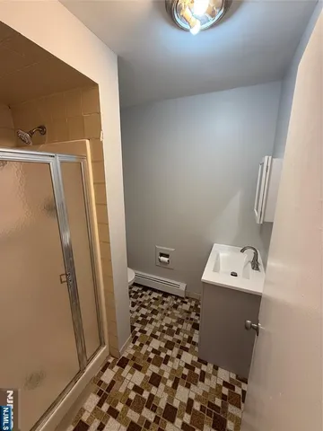 a bathroom with a sink a toilet and a mirror