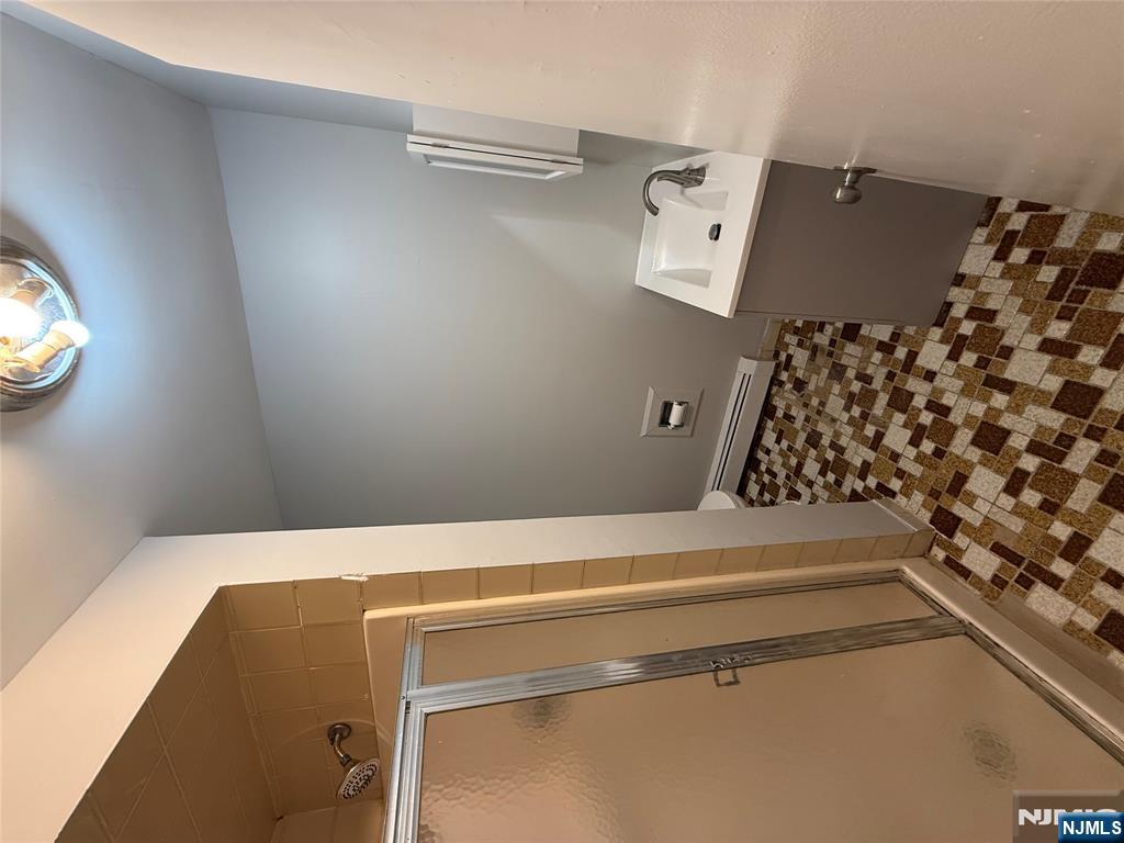 75 Lodi Street Hackensack, NJ 07601 - Photo 11 of 11 a bathroom with a sink a toilet and a mirror