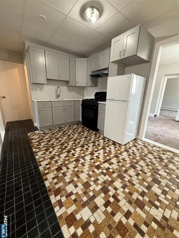 a kitchen with a refrigerator and a stove