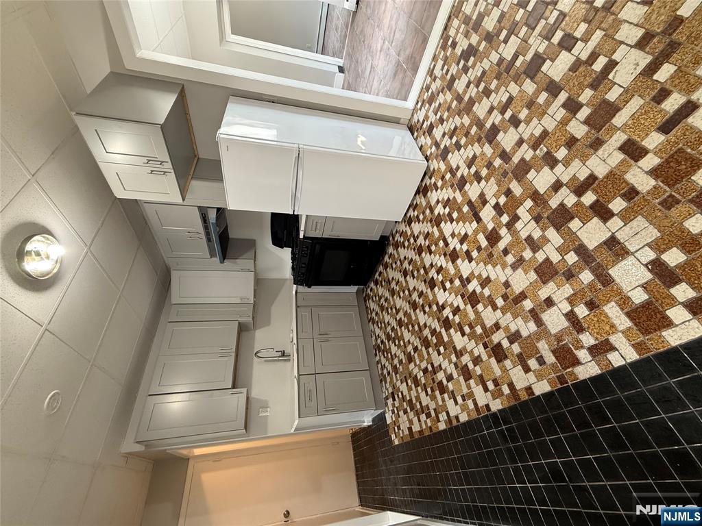 75 Lodi Street Hackensack, NJ 07601 - Photo 2 of 11 a kitchen with a refrigerator and a stove