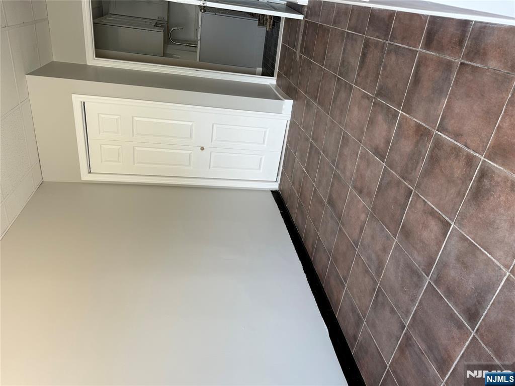 75 Lodi Street Hackensack, NJ 07601 - Photo 6 of 11 a view of an empty room with stairs and a window