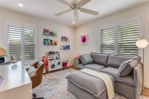 a bedroom with furniture and a large window