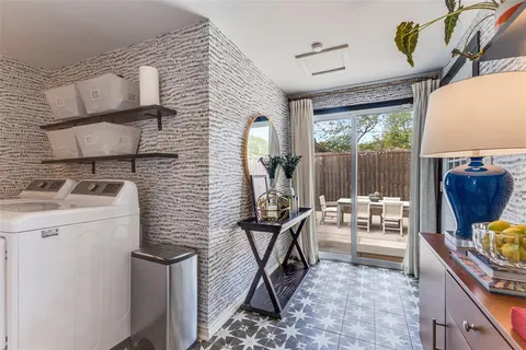 a view of a patio with table and chairs and potted plants