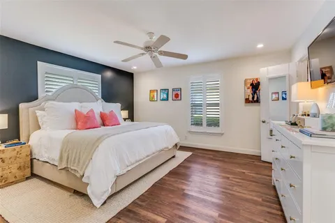 a bedroom with a large bed and a chandelier