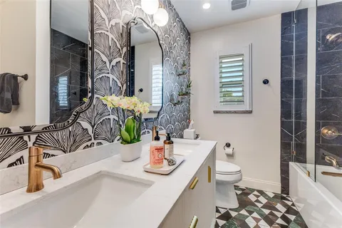 a bathroom with a sink a toilet and mirror