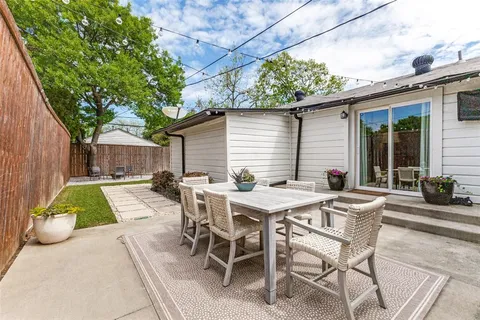 a view of a patio with table and chairs and potted plants