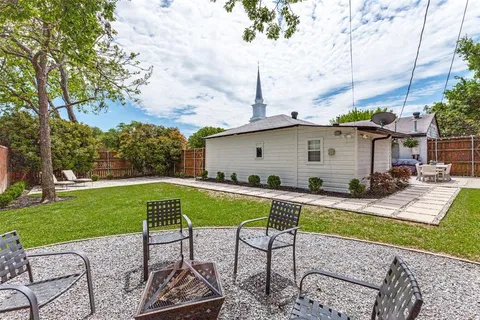 a view of a house with backyard sitting area and swimming pool