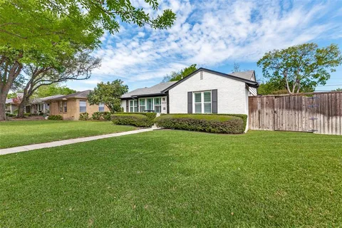 a house with huge green field in front of it