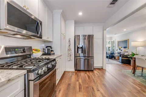 a kitchen with stainless steel appliances a stove a refrigerator and a microwave