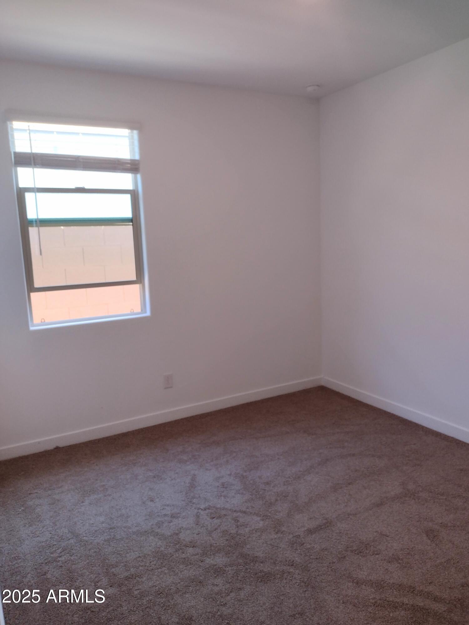1536 West Corral Road Phoenix, AZ 85041 - Photo 9 of 16 an empty room with a window